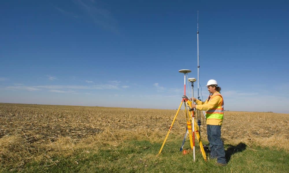 Licensed land surveyor conducting an ALTA survey on a property development site