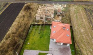 Aerial view of a property with existing and under-construction buildings, showing boundaries during an ALTA survey