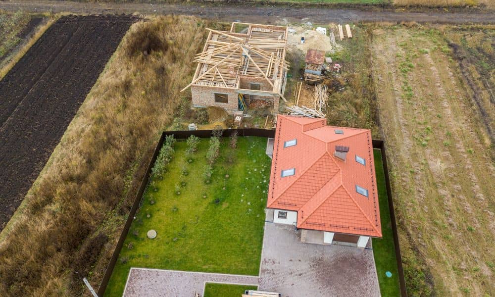 Aerial view of a property with existing and under-construction buildings, showing boundaries during an ALTA survey