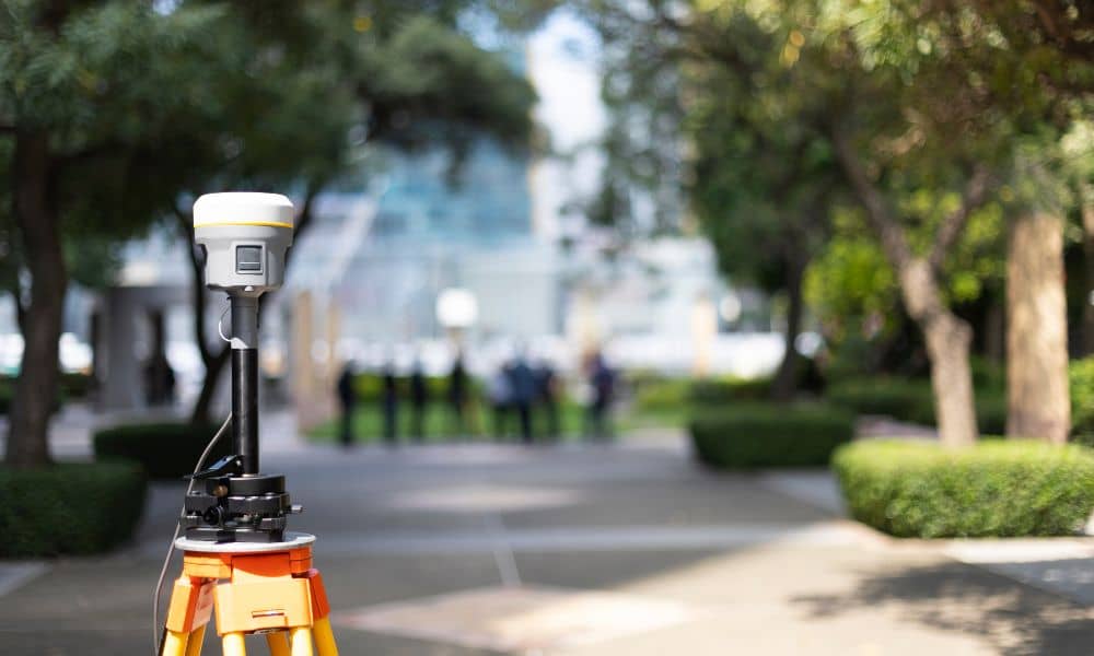 Surveying equipment set up for an ALTA land title survey on a commercial property site