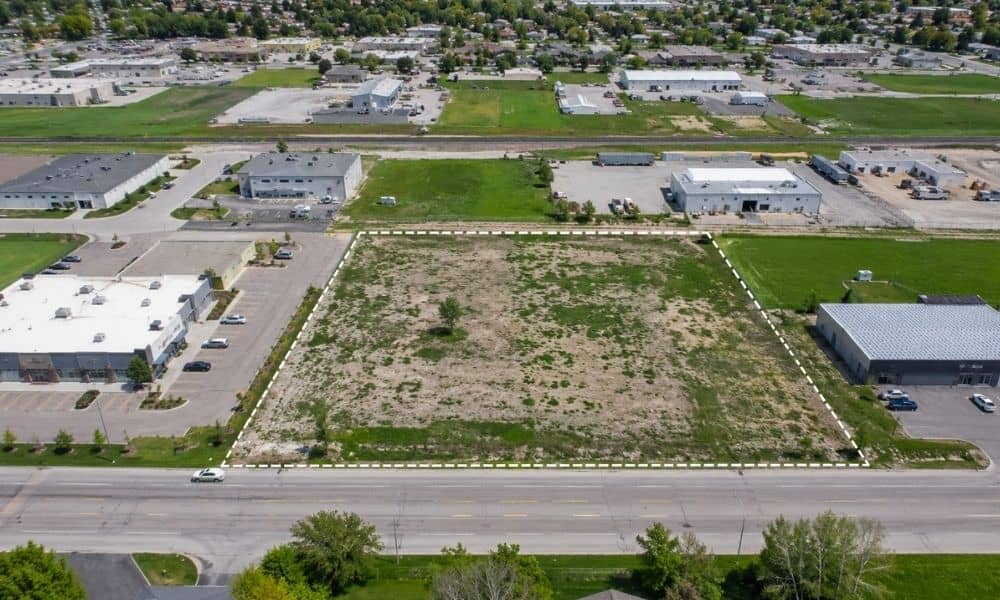 Aerial view of a commercial property with visible boundaries, roads, and surrounding development used to represent factors affecting ALTA survey costs